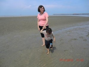 Caleb and his mother at the beach